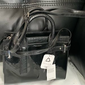 Black Tahari purse can be used with or without straps.